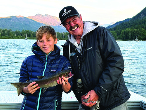 Calder and Dave Graybill holding a sockeye salmon from a tough fishing day on Lake Wenatchee.